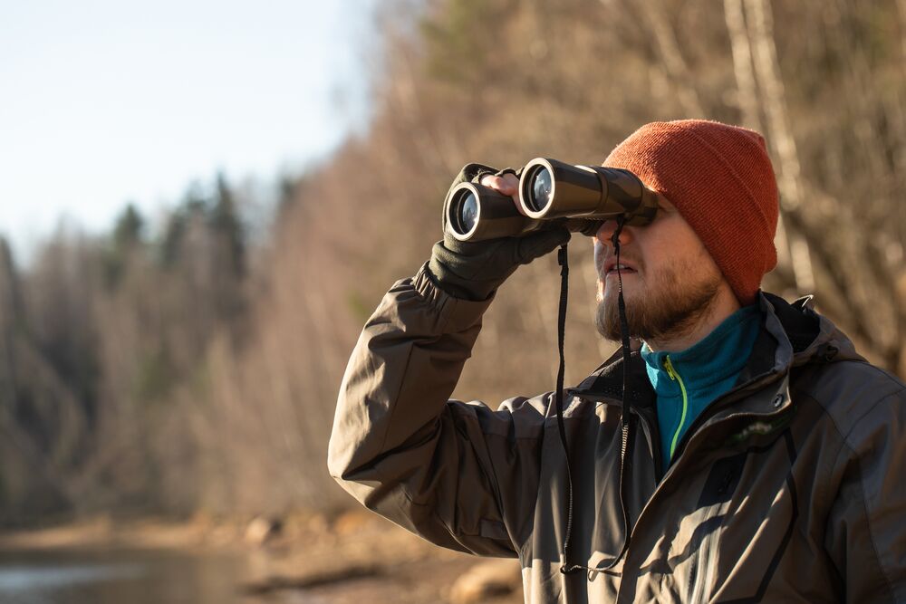 Hunter using binoculars in the field